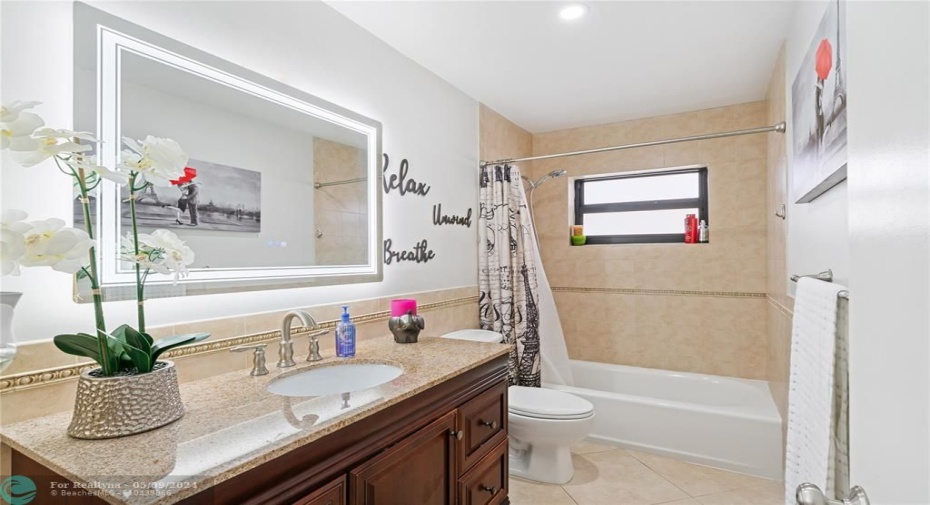 Guest bathroom featuring LED mirror.