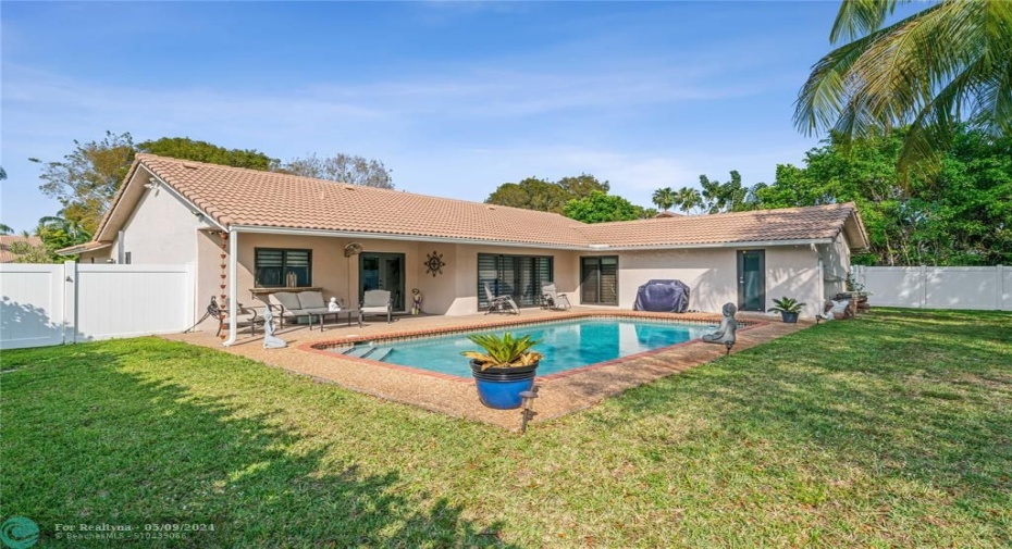Salt water pool surrounded by spacious, private backyard.