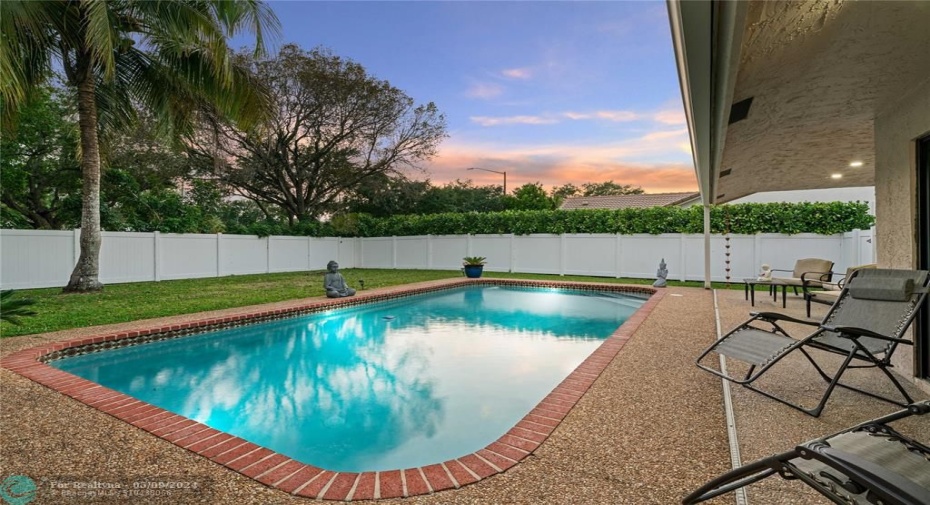 Watch the sunset each evening through the primary suite's hurricane-impact sliding door.