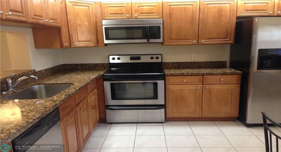 Modern Eat-In Kitchen Featuring Granite Counter Tops and Stainless Steel Appliances