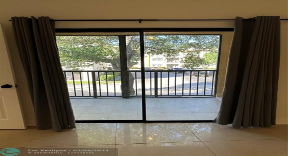 Spacious screened balcony with dual access points from the living area & master bedroom