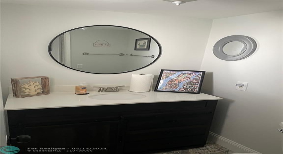 1/2 bath, newly remodeled with dramatic tile floor and unique barn door vanity