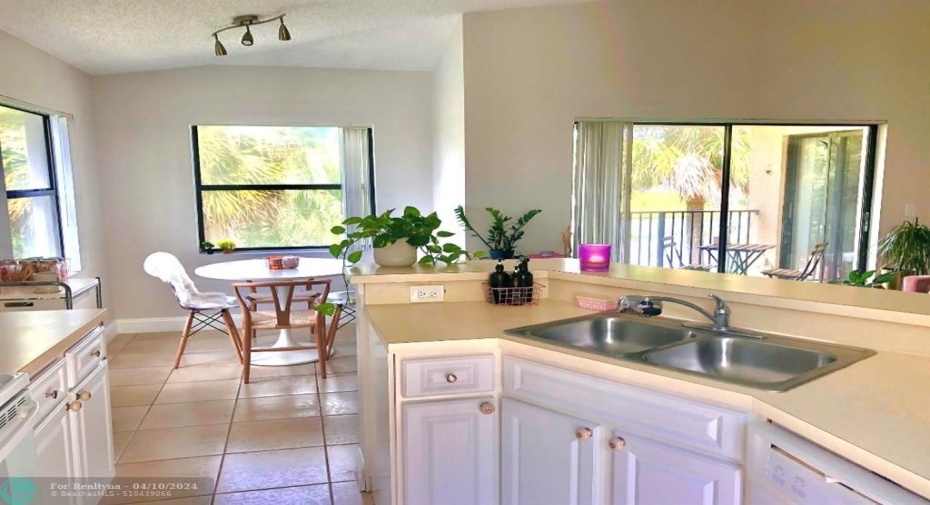 SPACIOUS KITCHEN WITH SEPARATE DINING AREA SURROUNDED BY WATER VIEWS