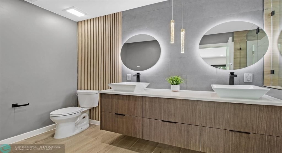 Large primary bath with double vanities and gorgeous lighting