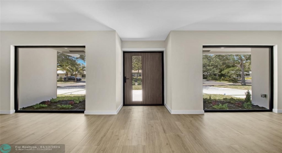 Inside view of front door and large floor to ceiling windows