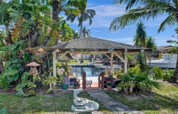 gazebo with view of the water and dock
