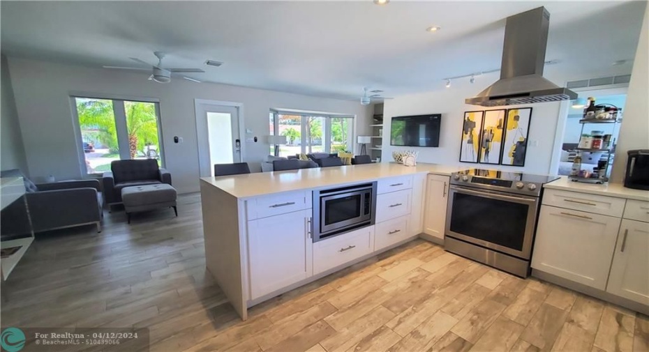 sleek open kitchen with breakfast bar seating...fabulous for entertaining
