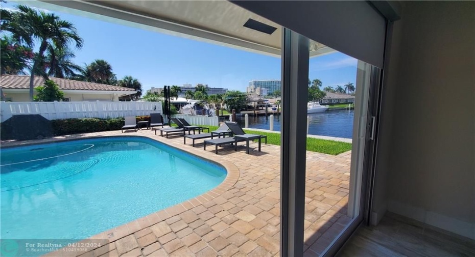 guest bedroom also overlooks pool and patio and water