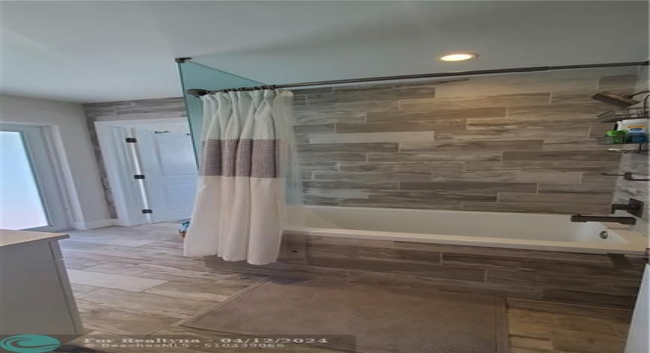 guest bathroom has combination tub and shower