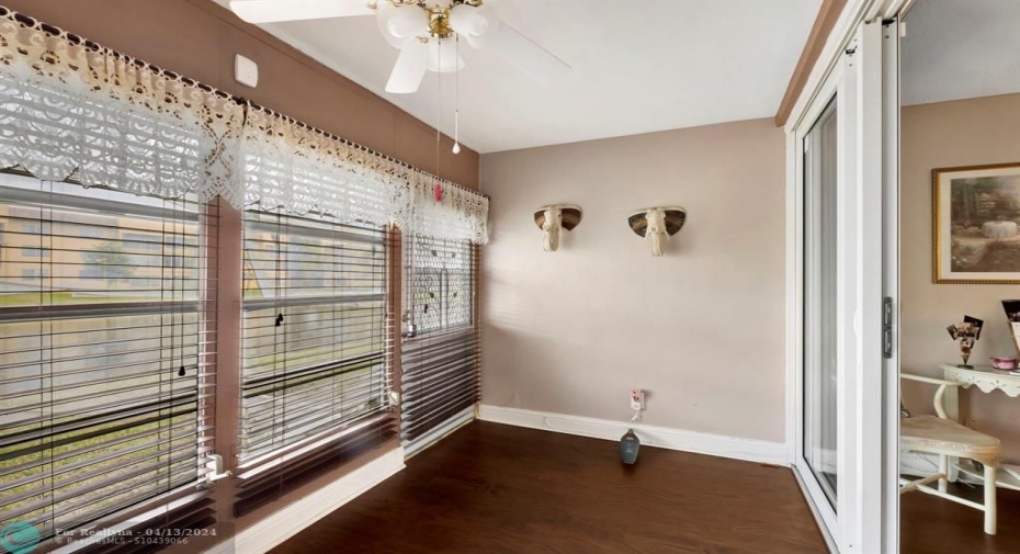 Glass enclosed patio. Hurricane impact door leads out to the patio/porch.