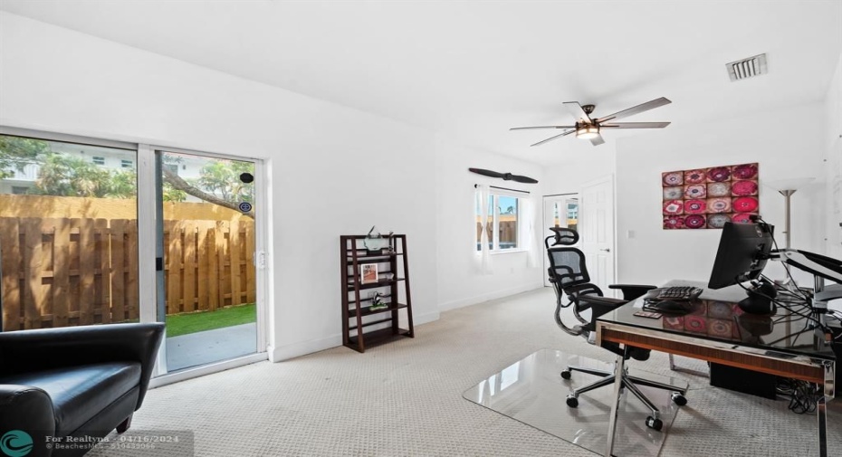 Lower level bedroom/office leads out to quaint patio