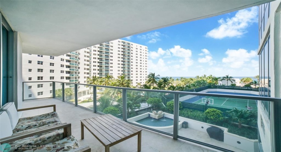 East balcony overlooking tennis court and ocean