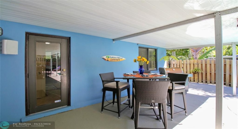 Covered patio that opens to cabanna bath, room for dining and grilling!