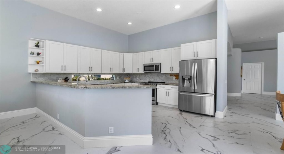 Chef's kitchen boasts stainless steel appliances, induction stove and convection oven.