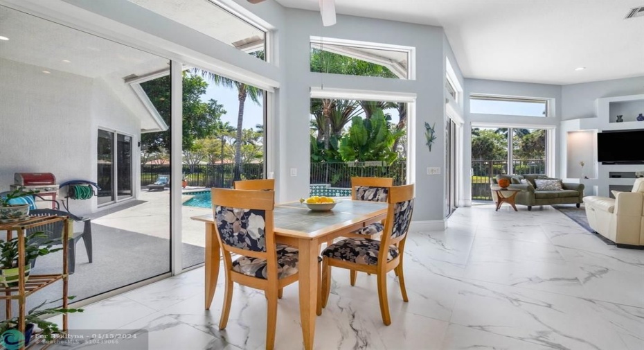 Dine in kitchen enables natural light and beautiful patio/pool and water views.