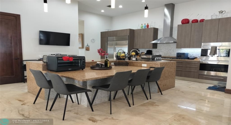 Oversized custom Island with seating area - sink in the island and cabinetry storage under