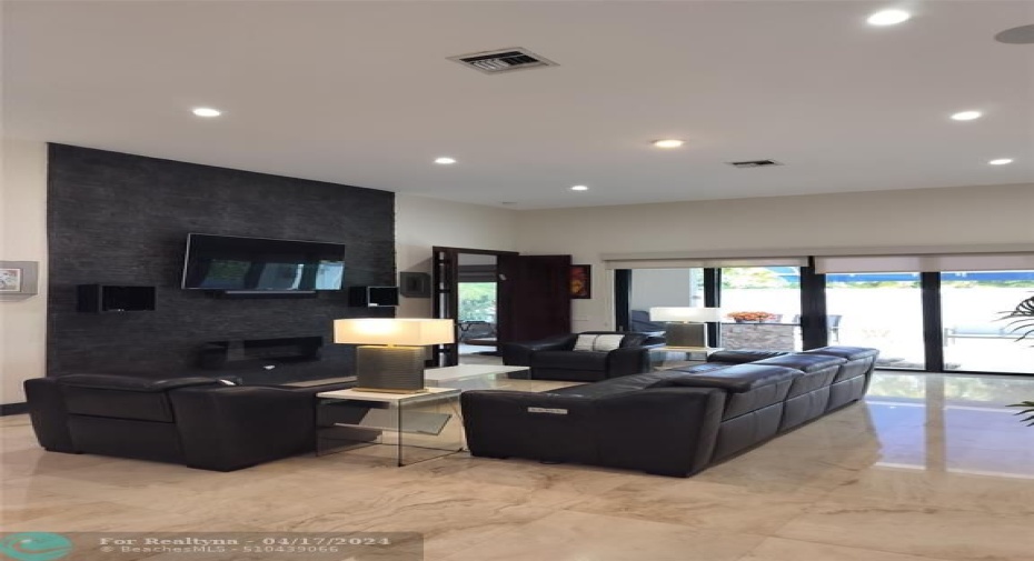Includes custom stone TV Wall, TV and electric fireplace