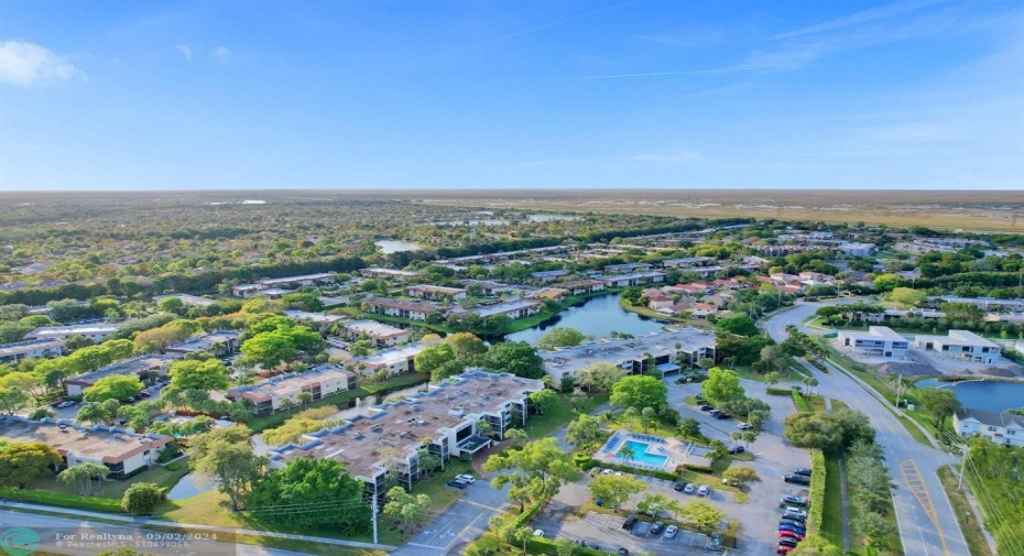 Aerial shot of building- heated pool view- plenty of parking - one dedicated pkg space/plenty of guest pkg