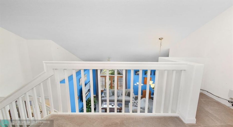 A NICE VIEW OF THE LIVING ROOM FROM LOFT