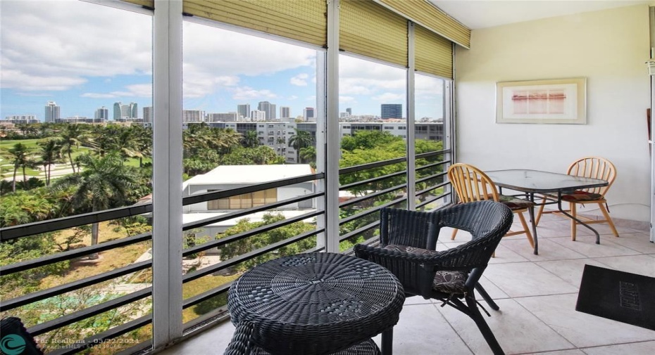 Balcony view of the ocean high rises in the distance