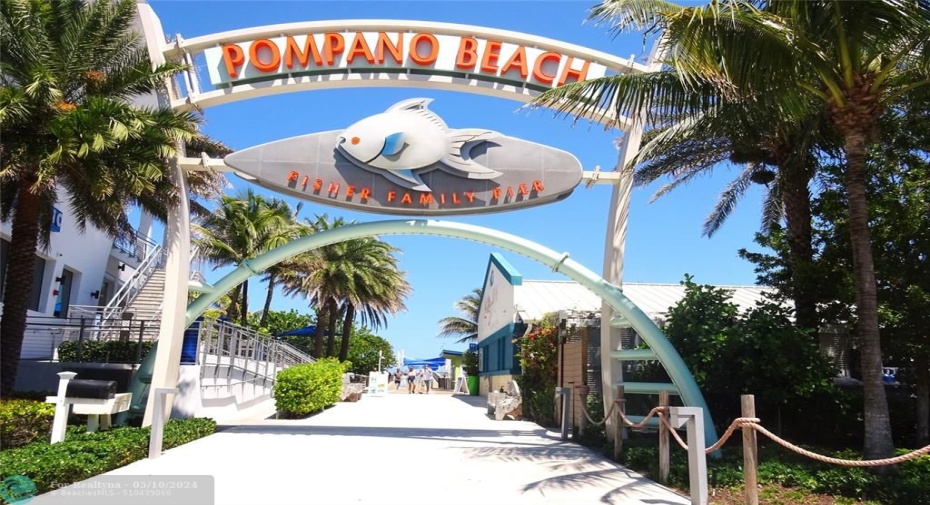 Pompano Beach Pier surrounded by stores and restaurants.
