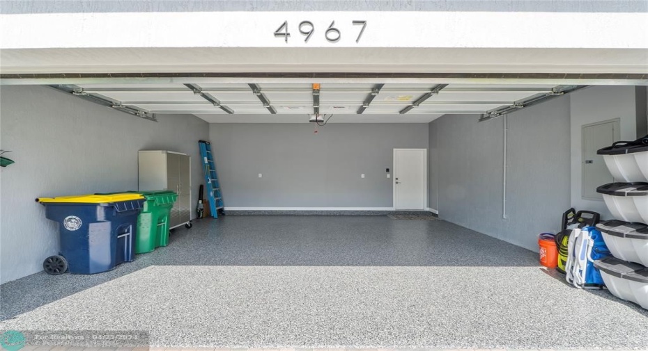 Garage features epoxy custom flooring