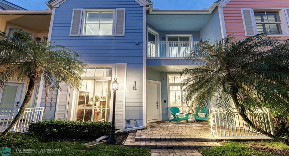 Bright and fun  with tropical landscaping and covered front porches