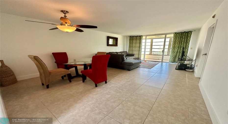 Fully tiled and spacious combination living and dining area with upgraded fan