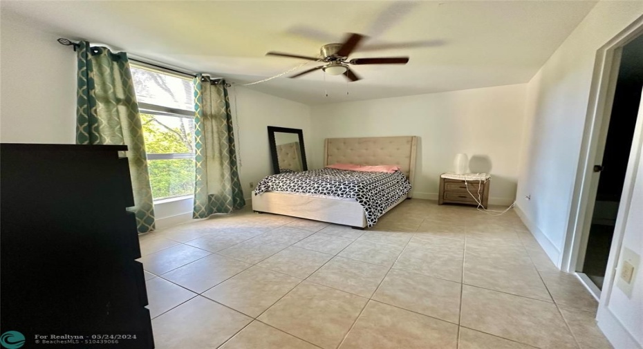 Fully tiled with upgraded baseboards and fan