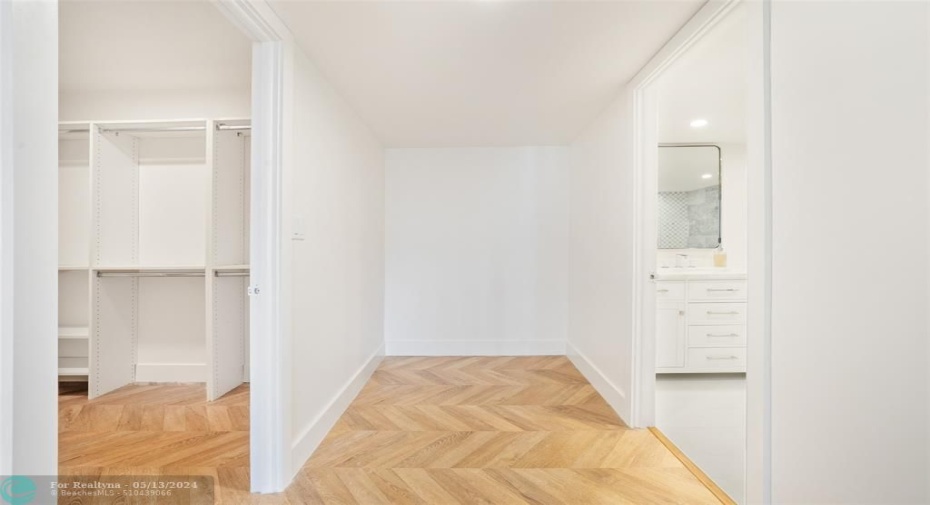 Hallway from 2nd bedroom to guest bathroom.  Huge walkin closet on left.