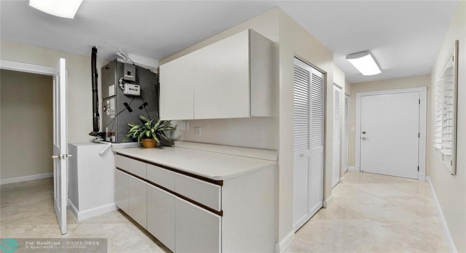 LAUNDRY ROOM WITH HALL TO EXTRA 3 CLOSETS-WINDOW - DOOR TO GARAGE