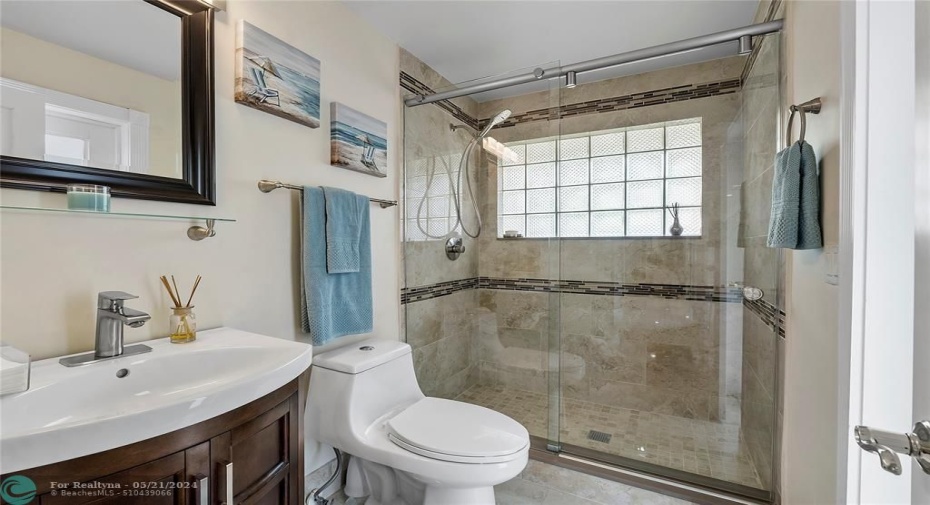 NEW UPDATED FULL BATHROOM WITH DOOR TO PATIO AND POOL.