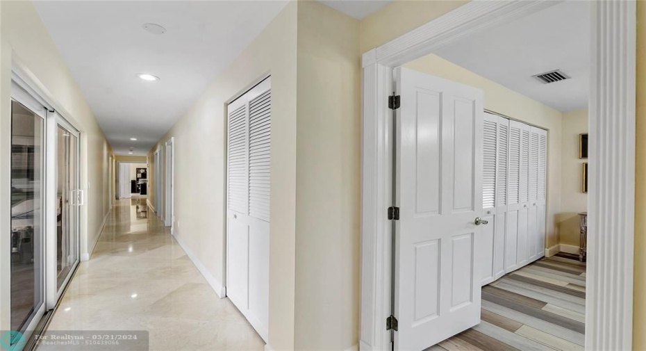 WIDE HALLWAY WITH SLIDER TO PATIO- ANOTHER CLOSET FOR STORAGE.