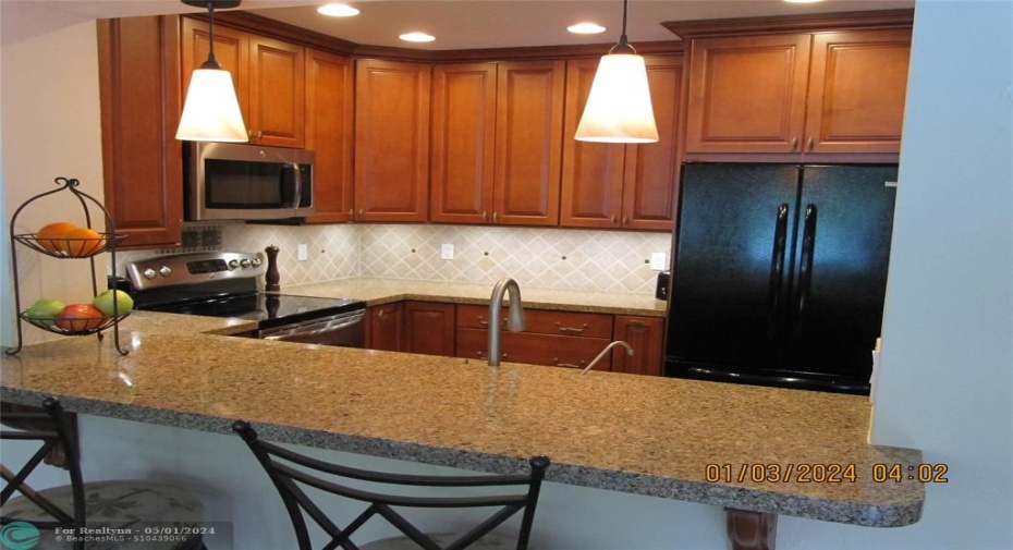 Looking over breakfast bar into kitchen