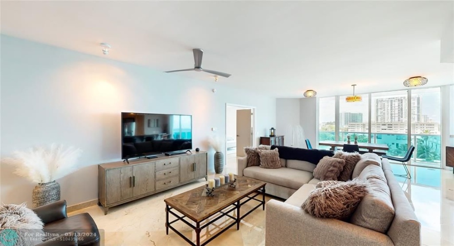 Grand living area with floor to ceiling windows with direct ocean views