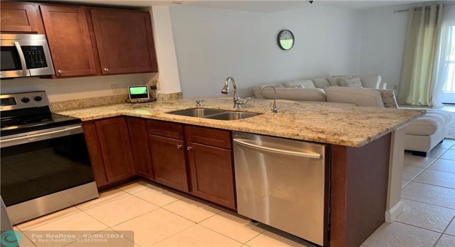 Open concept kitchen with full views to dining and living area and patio with water views. Full of natural light.