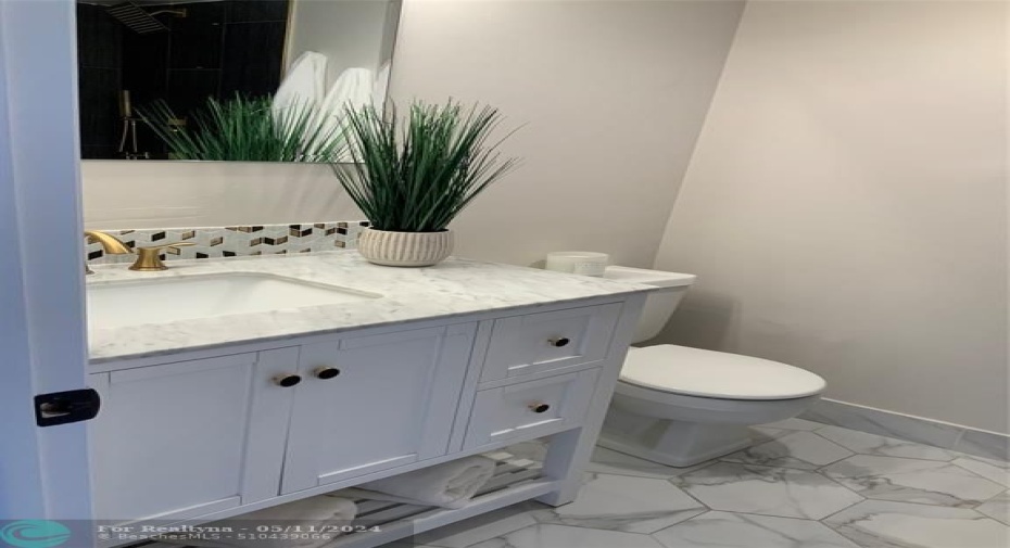 2nd Bath with marble countertop and gold fixtures