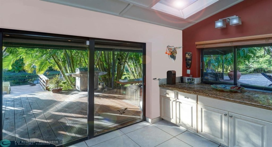 More kitchen counter space overlooking gorgeous deck and foliage