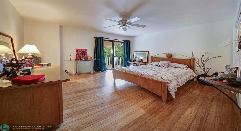 Bedroom with wood floors and balcony!