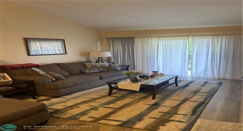 Vaulted ceilings, neutral colors and vinyl floors