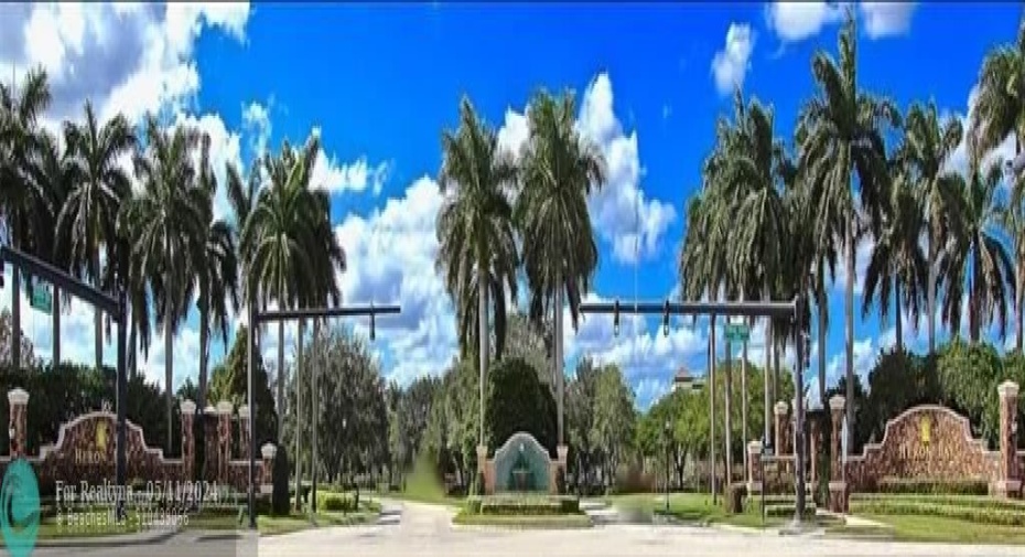 One of the Heron Bay gated entrances with guards 24/7