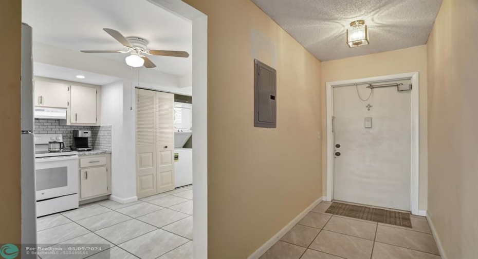ENTRY FOYER. FRONT DOOR WITH DOOR-CHECK (AUTOMATIC DOOR CLOSER)