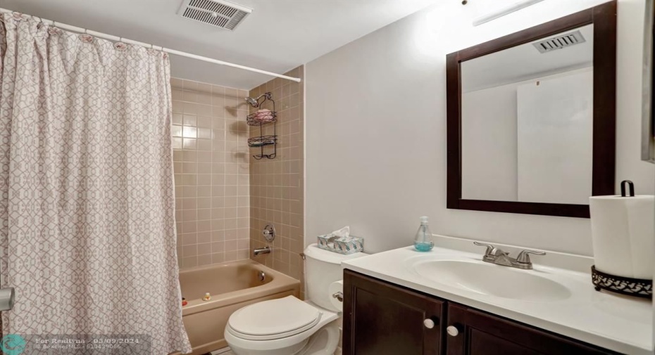 FLOOR TILE REPLACED 18X18. VANITY & MIRROR & COMMODE REPLACED. NEURAL COLOR TILE AND TUB.