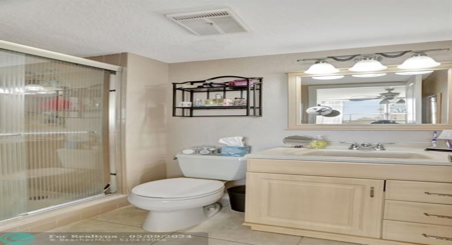 MASTER BATHROOM FLOOR TILE AND GLASS SHOWER DOOR REPLACED. VANITY LIGHT FIXTURE MIRROR AND COMMODE REPLACED.