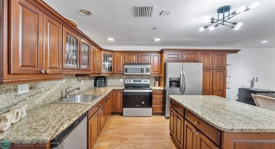 Updated wooden kitchen cabinets offers plenty of storage!