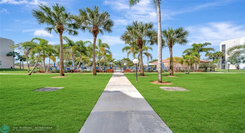 Well-Maintained Landscaping  & Sidewalk to Heated Pool