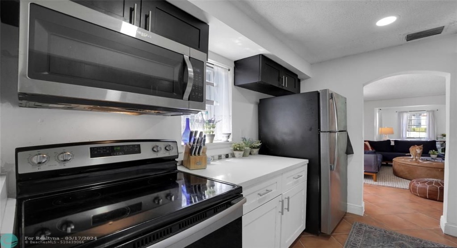 UPDATED KITCHEN W/ SS APPLIANCES - MODERN WHITE QUARTZ COUNTERS.