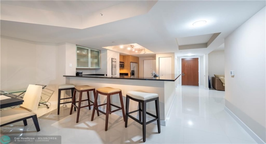 Front entry in the rear, bar top and den to the right