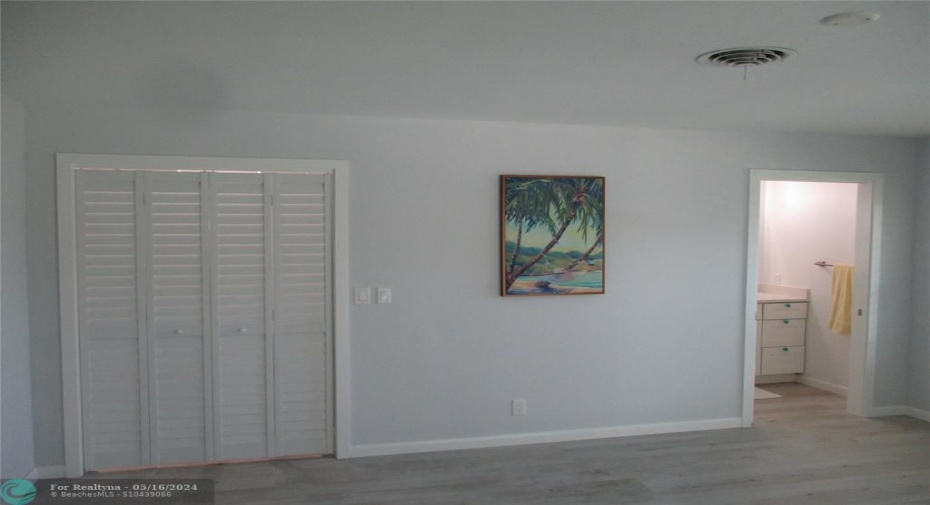 Primary Bedroom Walk-in Closet with en-suite to the right.