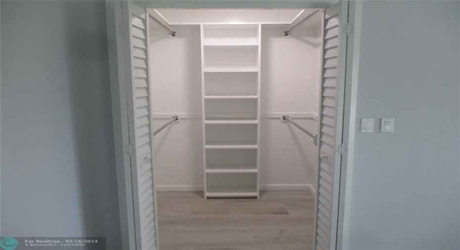 Primary Walk in Closet Freshly Painted with new Hardware.